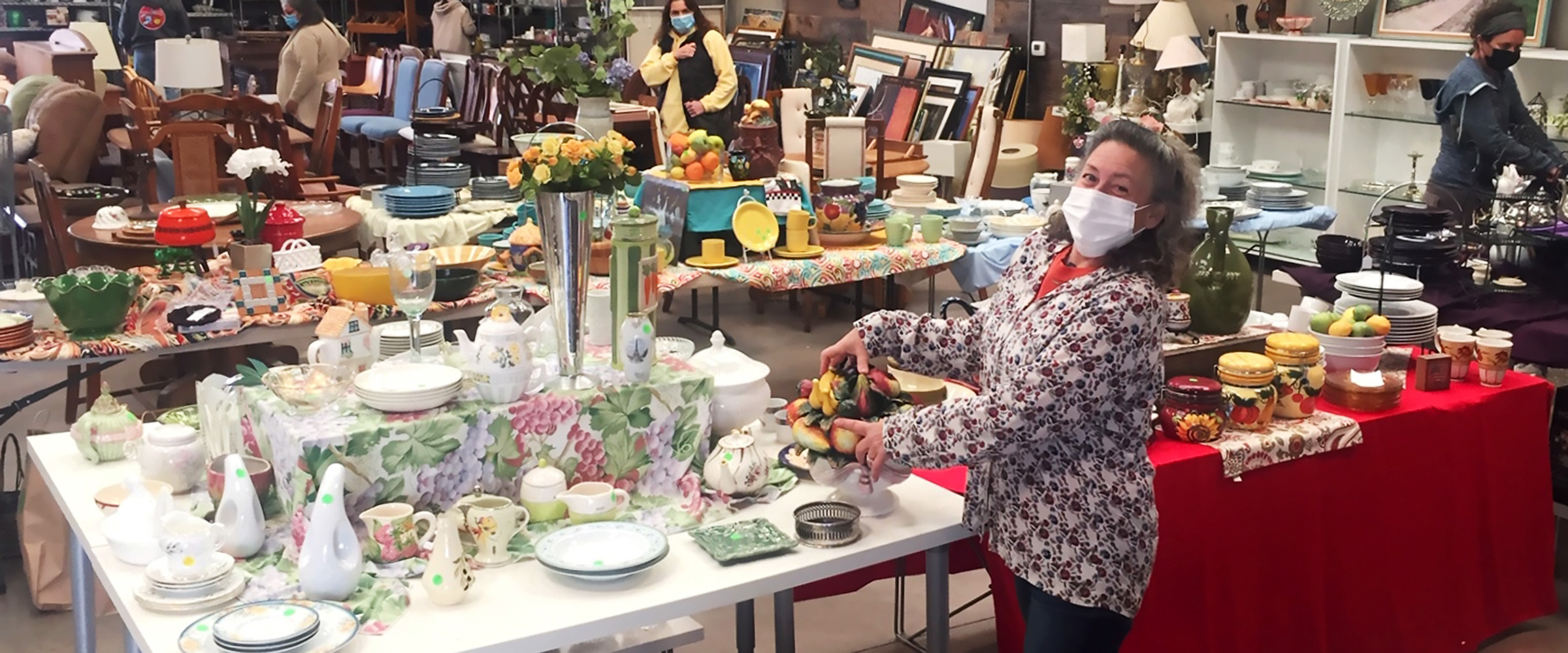 2 volunteers prepare electronics for re-sale